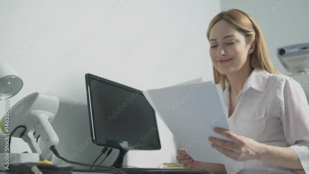 Agreeable female doctor looking at treatment results Agreeable female doctor looking at treatment results