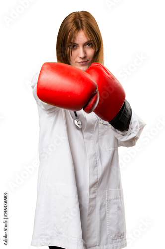 Young doctor woman with boxing gloves
