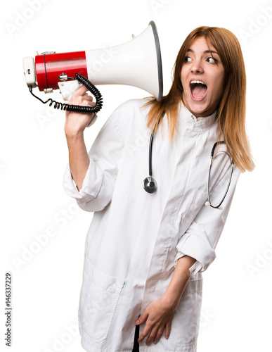 Young doctor woman holding a megaphone