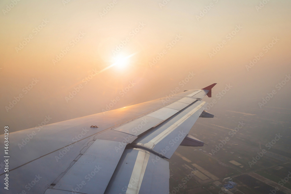 Evening sunset with Wing of an airplane. Photo applied to tourism as Traveling concept.