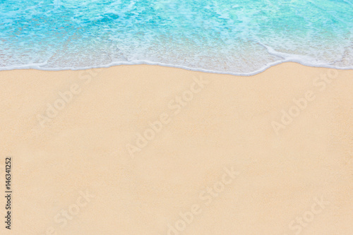 Soft wave of Blue ocean on sandy Beach. Abstract natural Background.
