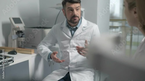 Chief optometrist consulting young doctor