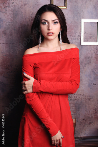 Beautiful brunette girl in red dress.