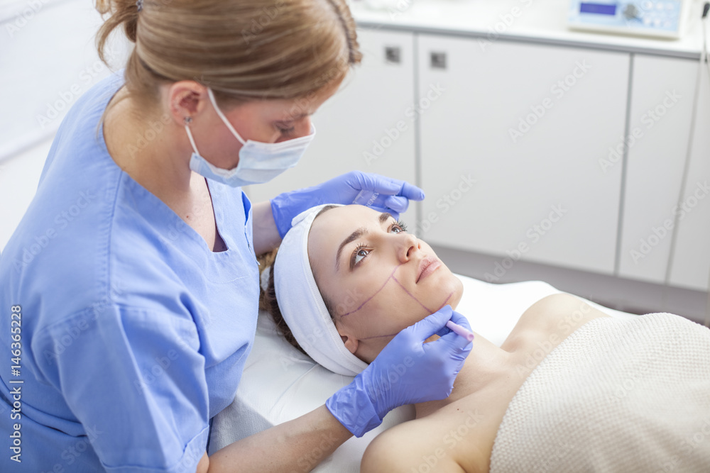 Young beautiful woman in the beauty salon on the face treatment