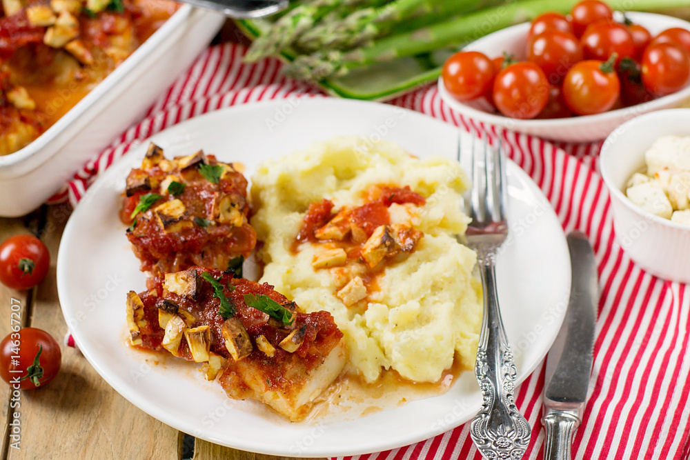Fish cod baked in tomato sauce with feta cheese Fish cod baked in tomato sauce with feta cheese