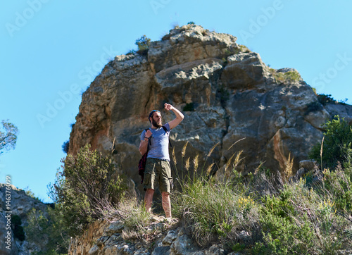Man traveler standing on a mountain edge 