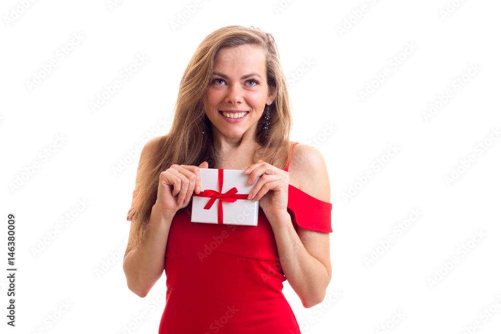 Young woman in red dress holding present Young woman in red dress holding present