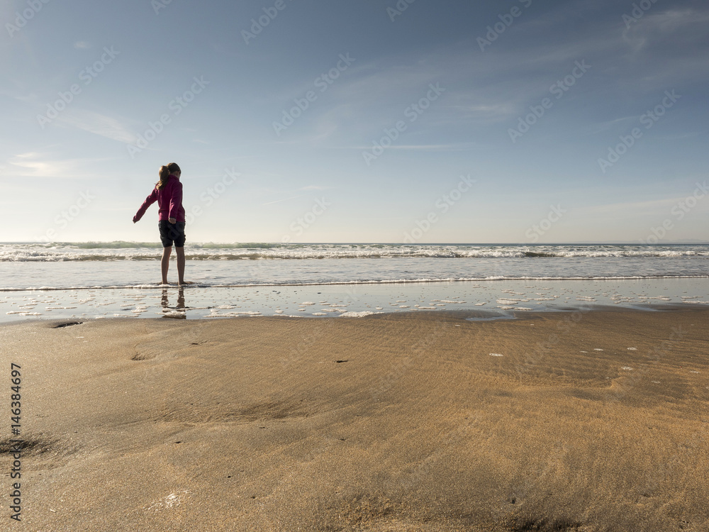 Girl with her feet in water.