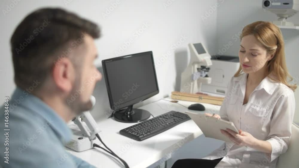 Male patient having consultation with eye doctor Male patient having consultation with eye doctor