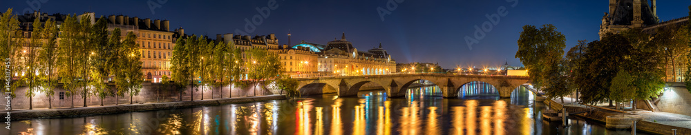 Panoramic view on the Seine River banks, the Pont Royal bridge, and Orsay Museum at dawn. Paris, 7th Arrondissement, France