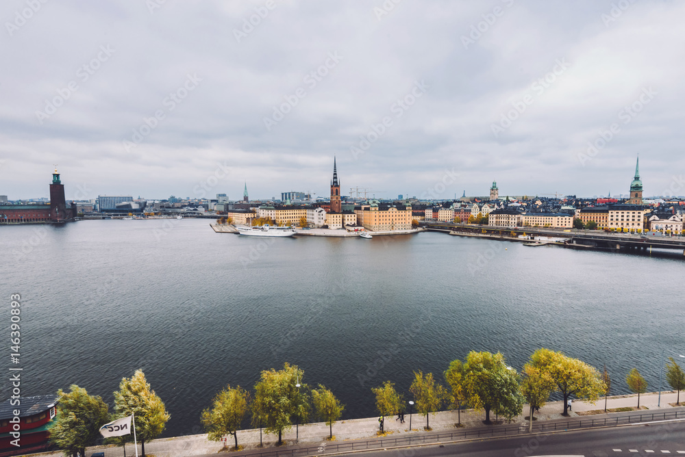 Fototapeta premium Stockholm panorama with Old Town Gamla Stan and Centralbron bridge view from Monteliusvagen in Sodermalm island. Stockholm skyline with City Hall, Riddarholm Church and Old German Church, Sweden.
