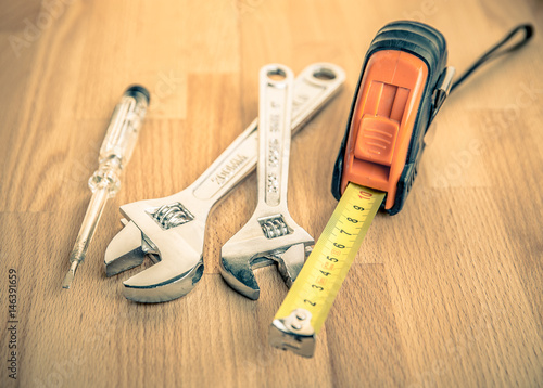 Measuring tape and Adjustable Wrenches on table