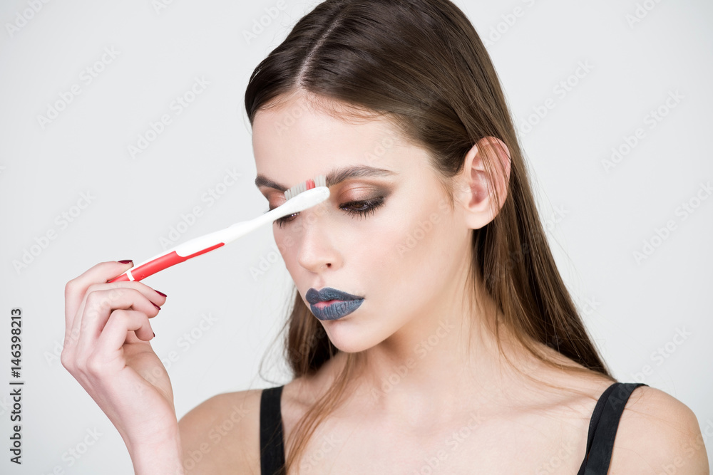 girl with teeth brush, has fashionable makeup girl with teeth brush, has fashionable makeup