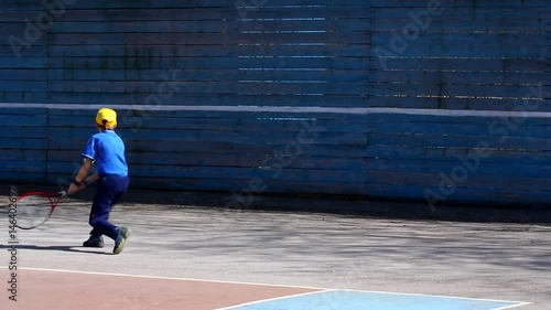 boy playing tennis