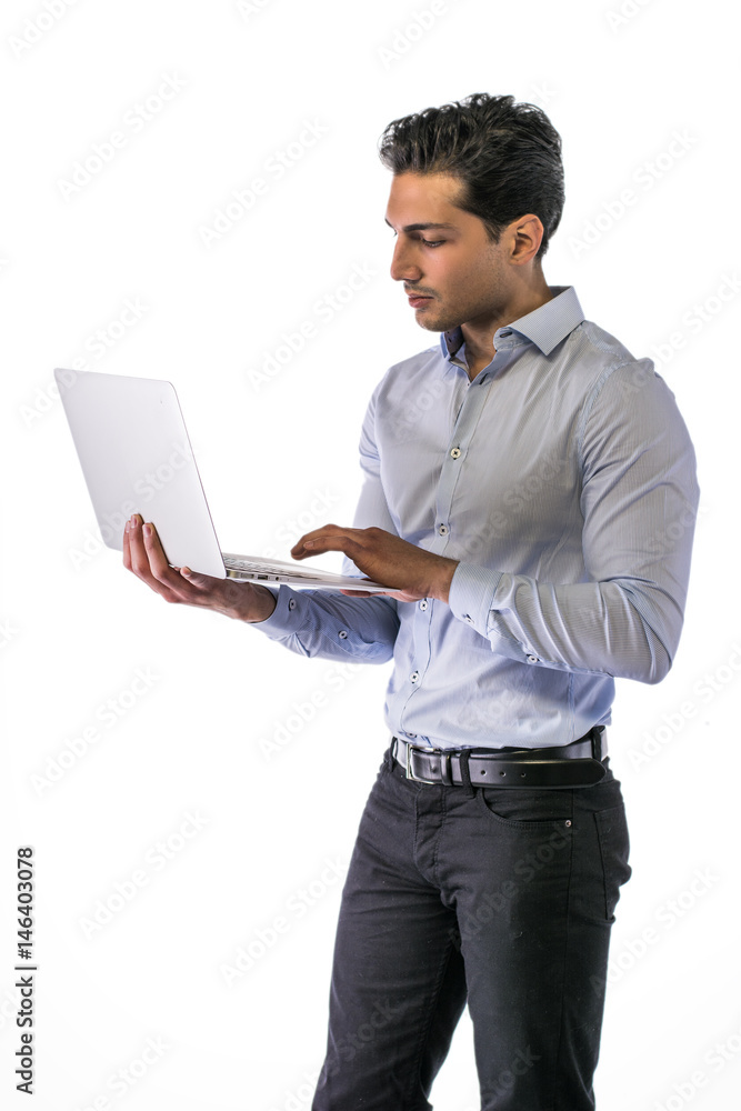 Young attractive man working with computer while standing, isolated on white background Young attractive man working with computer while standing, isolated on white background