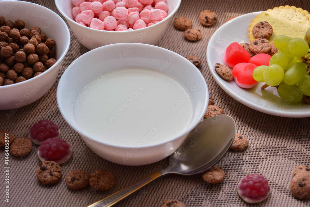 A plate of milk, grapes and crispy balls for breakfast A plate of milk, grapes and crispy balls for breakfast