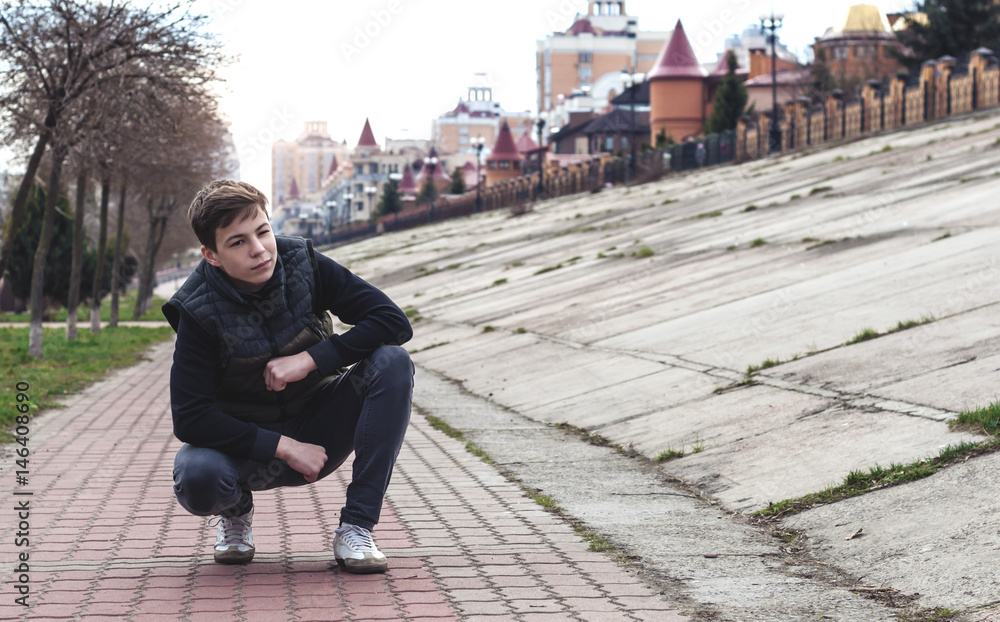 Stylish young man on the city embankment Stylish young man on the city embankment
