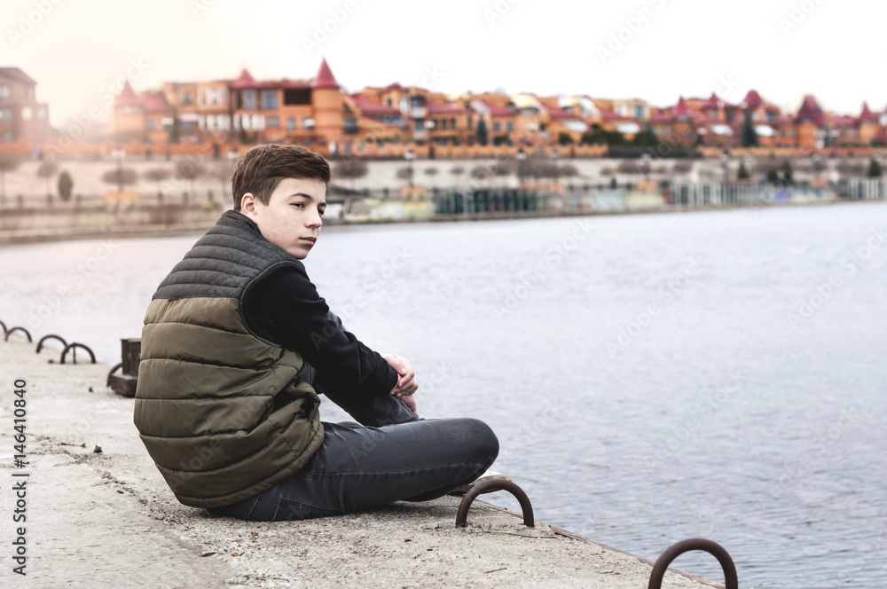 Fototapeta premium Stylish young man on the city embankment