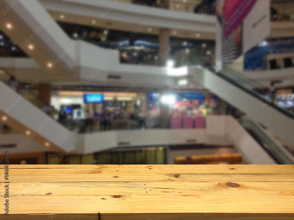 Empty wooden table space platform and blurred shopping mall background for product display montage Empty wooden table space platform and blurred shopping mall background for product display montage