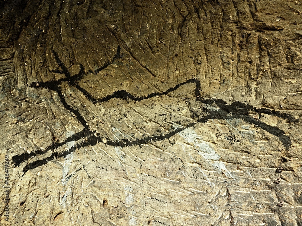 Caveman symbols on sandstone wall. Paint of human hunting, prehistoric picture. Caveman symbols on sandstone wall. Paint of human hunting, prehistoric picture.