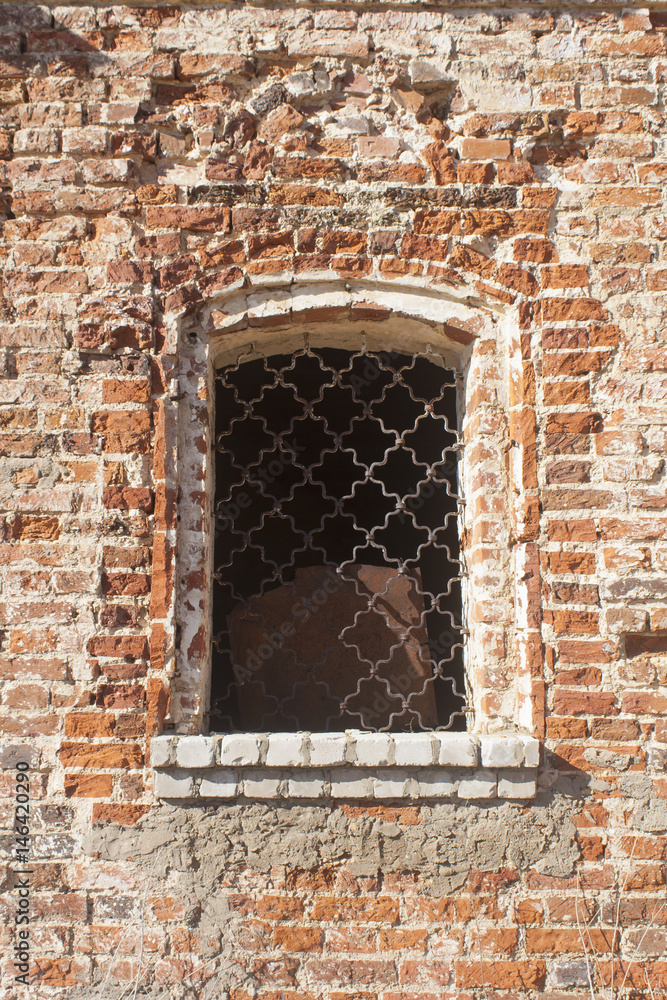 Barred window in a brick wall