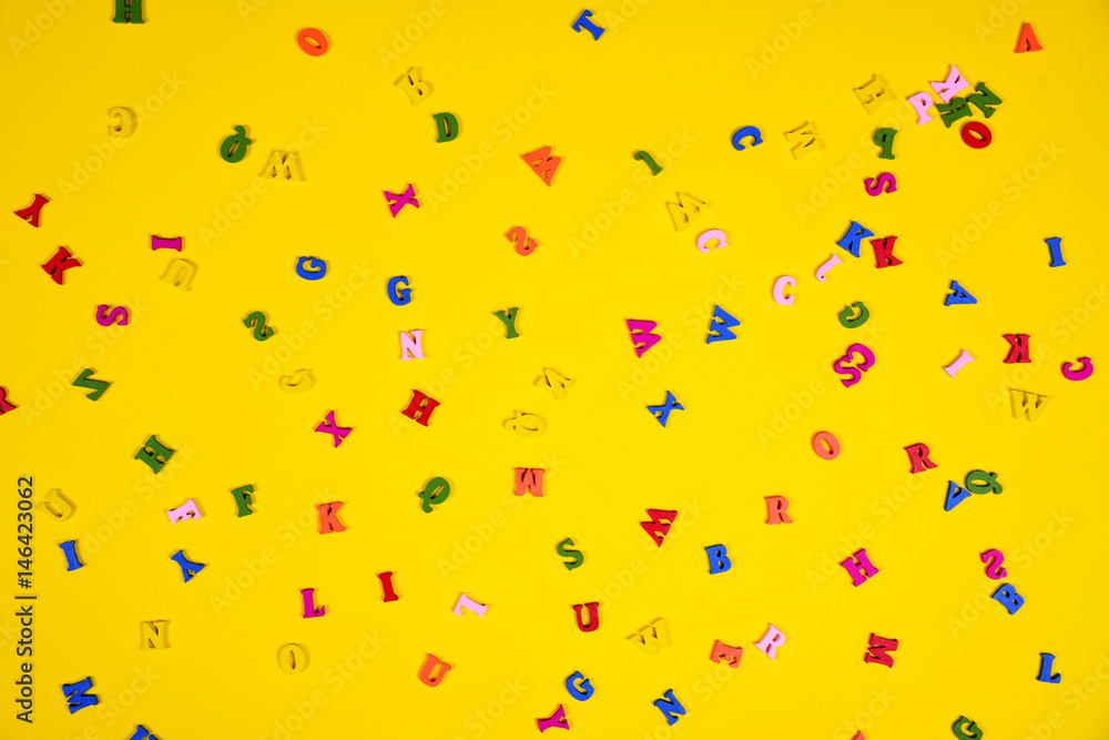 Yellow background with multi-colored wooden letters