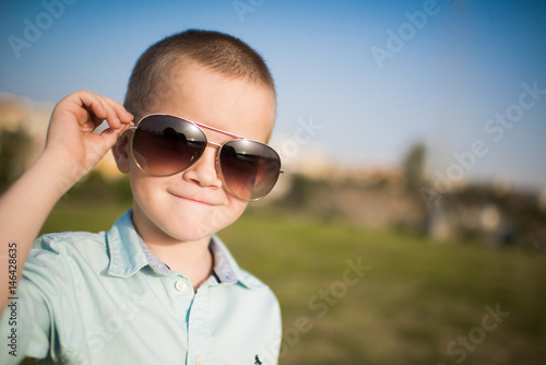 Boy in sunglasses smiling
