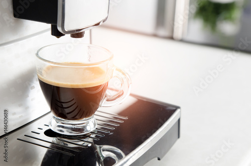 Home professional coffee machine with espresso cup.