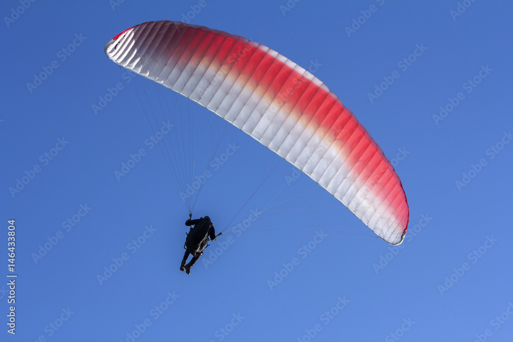 Paraglider flying in the blue sky as background Paraglider flying in the blue sky as background