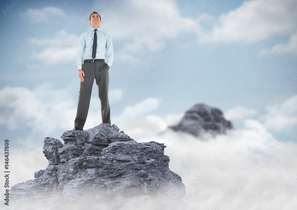 Business man hand in pocket on mountain peak in clouds Business man hand in pocket on mountain peak in clouds