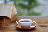Stock Photo - Coffee cup & book on wood table - vintage (retro) style color effect with soft focus