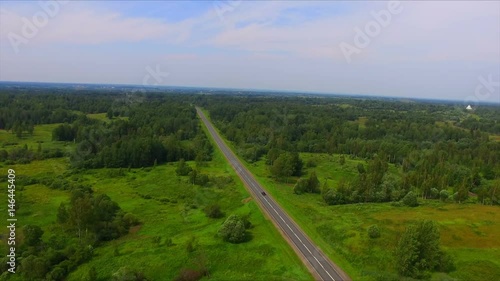 Drone flight over the highway among the green forests photo