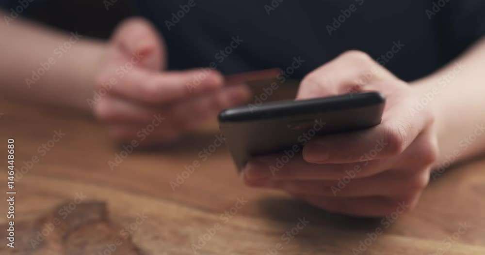 Slow motion of young female teen hand using smatphone to buy something, 4k 60fps prores footage Slow motion of young female teen hand using smatphone to buy something, 4k 60fps prores footage