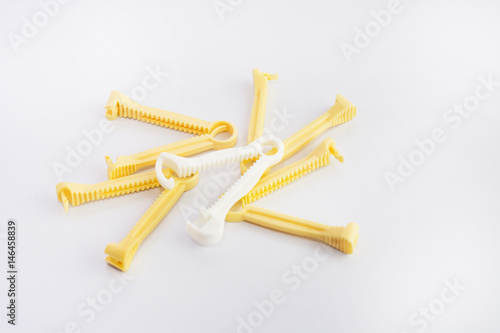 Canvas Print Yellow and White umbilical cord clamp used to clamp off the umbilical cord after a baby's birth