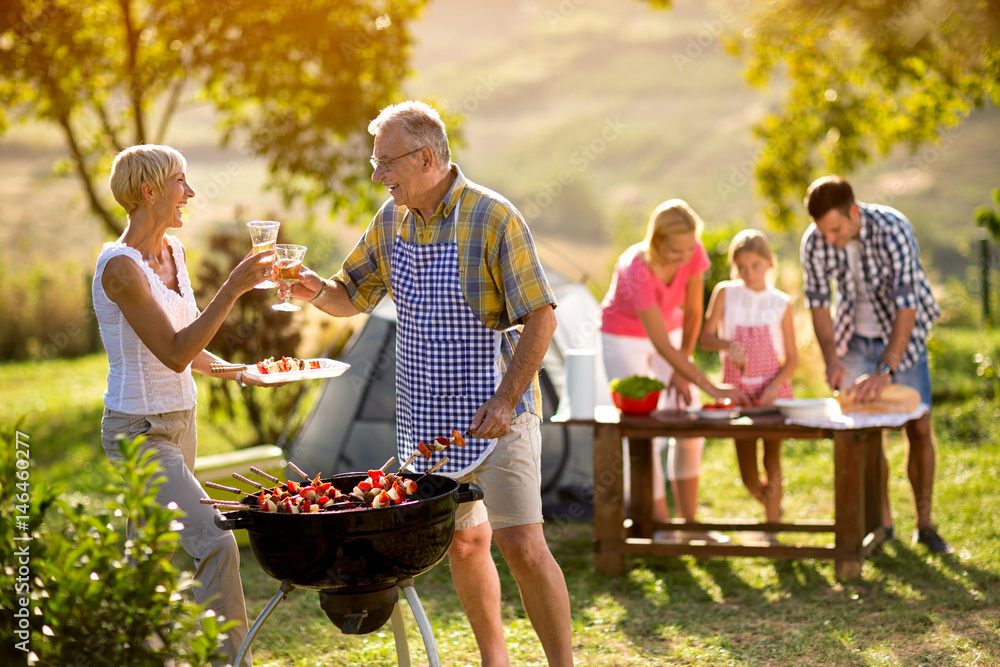 Obraz premium happy grandparents drink wine.