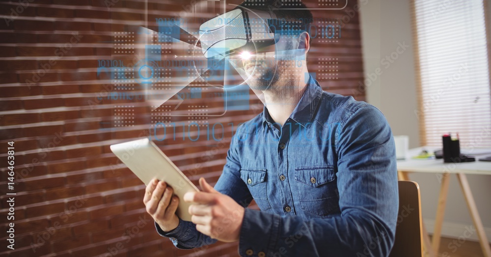 Fotografie Businessman wearing VR glasses while holding tablet PC