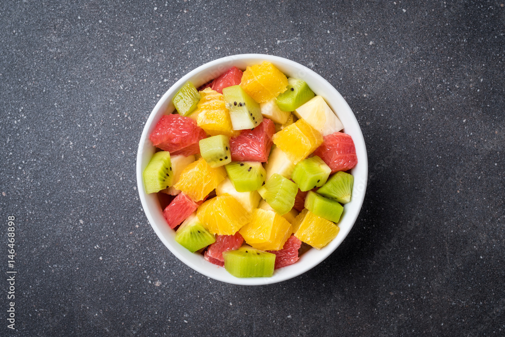 Εκτύπωση καμβά Colorful fruit salad on gray stone table. Food background