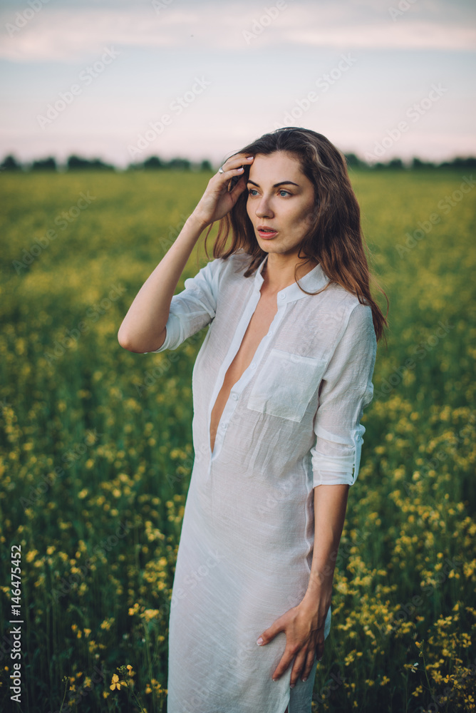 Girl walking in the field at sunset Girl walking in the field at sunset