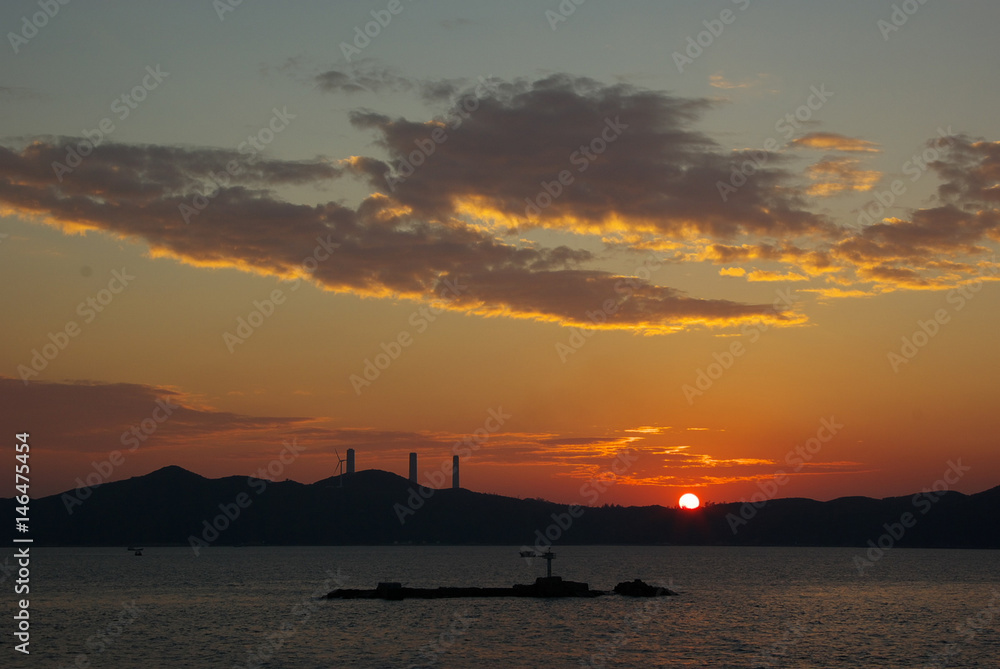 Sunset with an island and stacks silhouette