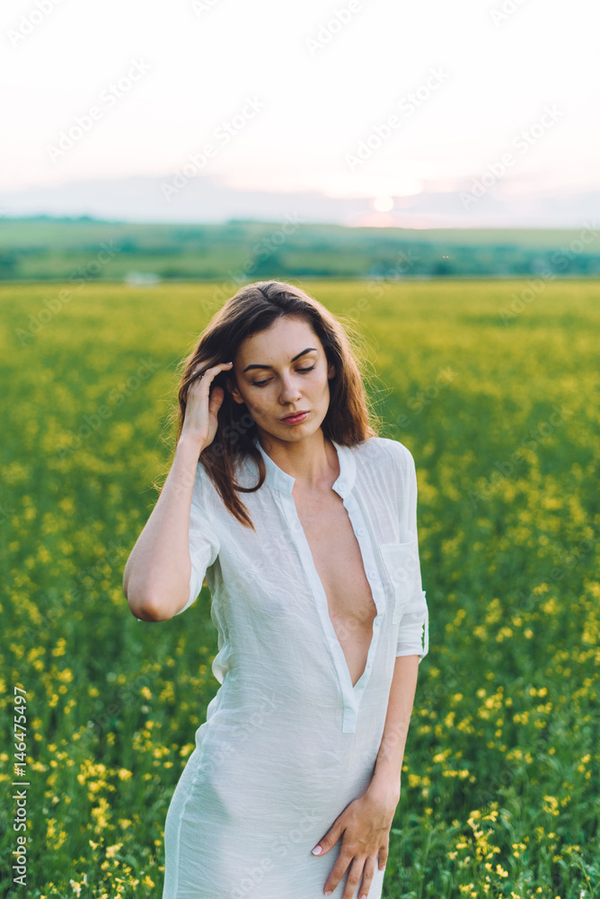 Girl walking in the field at sunset Girl walking in the field at sunset