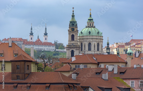 St Nicholas Church dome above traditional red roof tops of Mala Strana in Prague