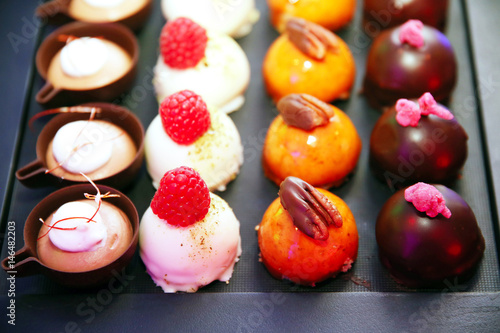Variety of colorful modern french sweet desserts different fillings