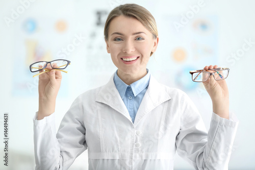 Female doctor holding glass...