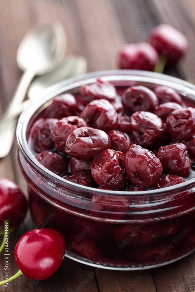 Berries cherry with syrup in a glass jar. Canned fruit Berries cherry with syrup in a glass jar. Canned fruit