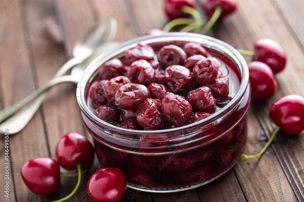 Berries cherry with syrup in a glass jar. Canned fruit Berries cherry with syrup in a glass jar. Canned fruit
