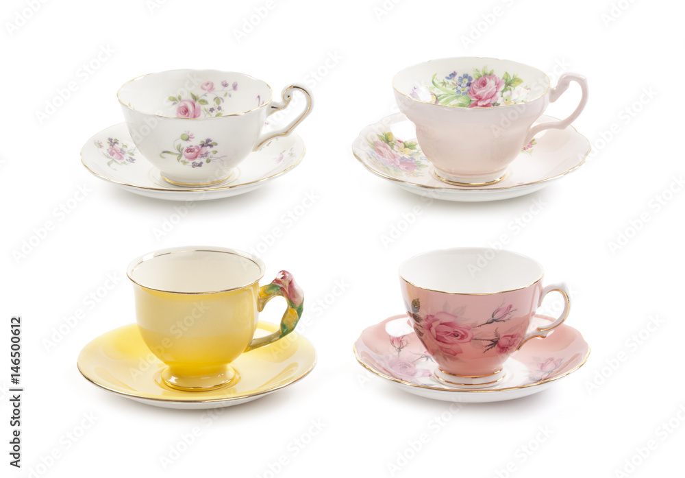 High resolution close-up of four beautiful antique tea cups with saucers isolated on a white background. High resolution close-up of four beautiful antique tea cups with saucers isolated on a white background.