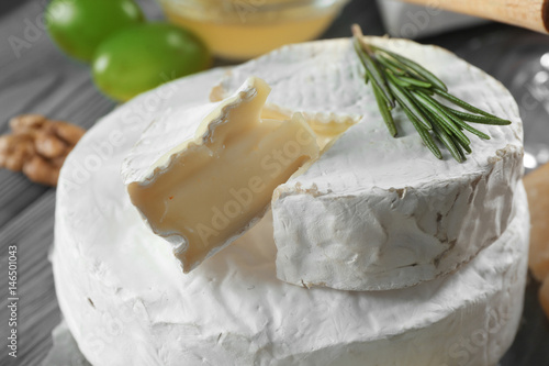 Soft cheese with fresh rosemary on top, closeup