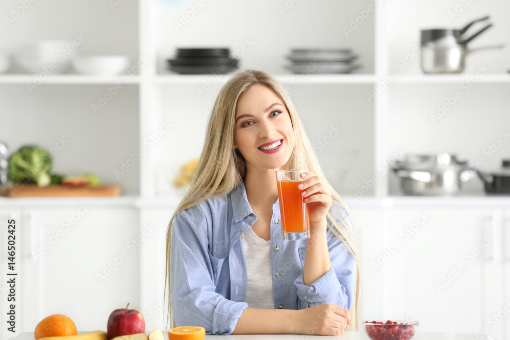Beautiful young woman with glass of fresh juice in kitchen Beautiful young woman with glass of fresh juice in kitchen