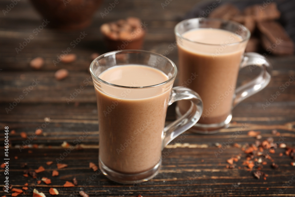 Glass cups of cocoa on wooden table Glass cups of cocoa on wooden table