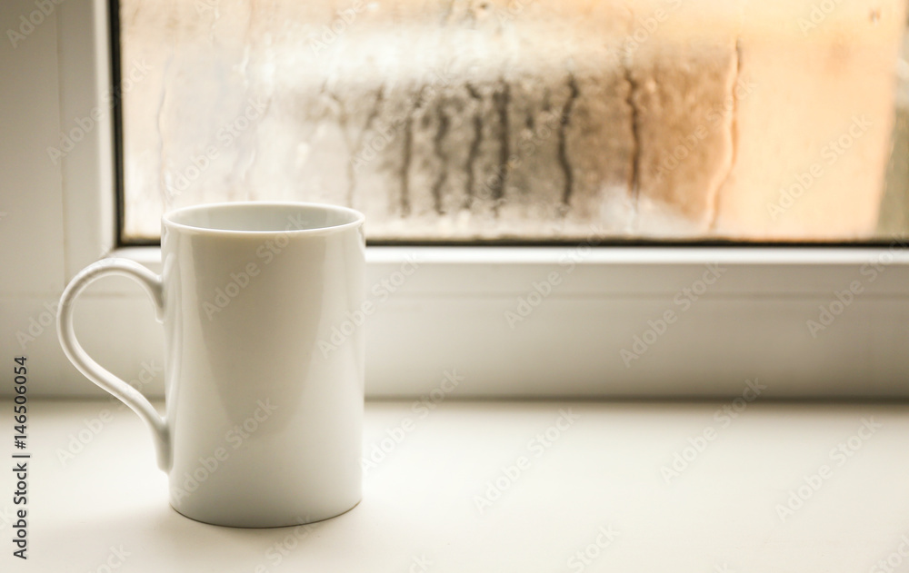 Cup of hot tea on window sill Cup of hot tea on window sill